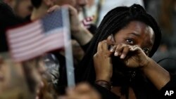 A woman weeps as election results are reported, Nov. 8, 2016, during Democratic presidential nominee Hillary Clinton's election night rally in the Jacob Javits Center glass enclosed lobby in New York.
