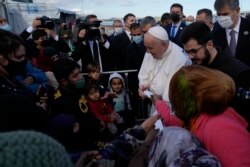 Pope Francis meets with migrants during his visit at the Karatepe refugee camp, on the northeastern Aegean island of Lesbos, Greece, Dec. 5, 2021.