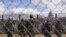 National Guard members salute in front of the U.S. Capitol building during the inauguration of President-elect Joe Biden in Washington, Jan. 20, 2021. 