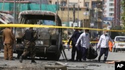 Health workers retrieve a body after an attack that targeted a bus carrying mostly government employees in Kabul, Afghanistan, June 3, 2019.