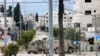 Israeli troops man a position at the entrance of the occupied West Bank refugee camp of Tulkarem, during an ongoing military raid on Feb. 21, 2025. 