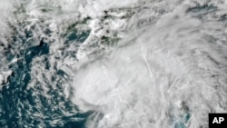 FILE - This July 6, 2021 satellite image shows Tropical Storm Elsa in the Gulf of Mexico off the coast of Florida. NOAA updated its outlook for the 2021 Atlantic season, slightly increasing the expected number of named storms and hurricanes. 