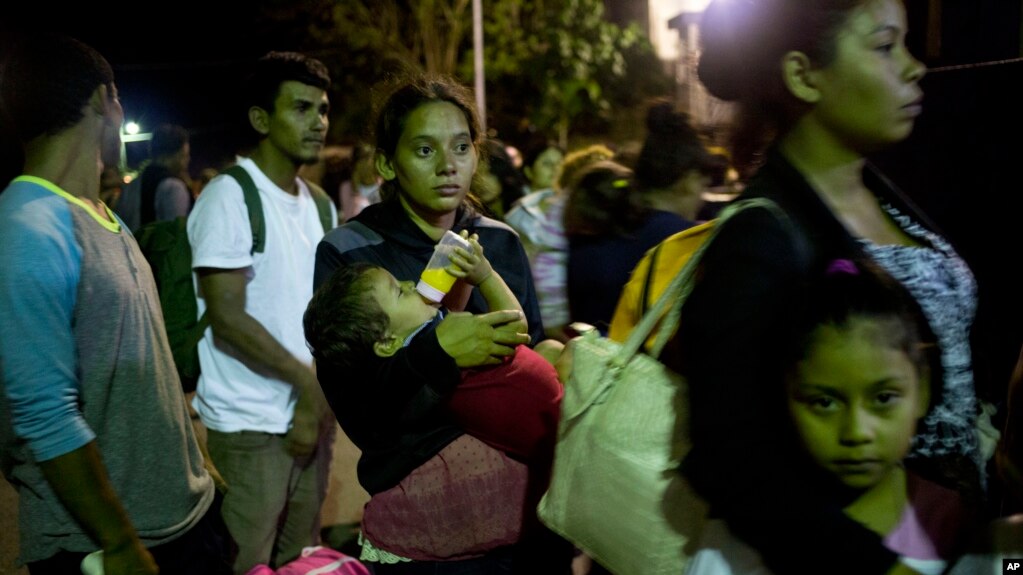 Glasys Menjiva lleva en brazos a su hijo de 16 meses mientras aguarda en la lÃ­nea para cruzar la frontera en Agua Caliente, Guatemala. Ella forma parte de la caravana de migrantes que iniciÃ³ el viaje rumbo a EE.UU. el martes.