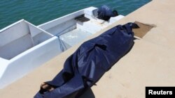 FILE - A bag containing the body of a migrant who died in an unsuccessful crossing of the Mediterranean Sea is seen in the twon of Qarabulli, east of the capital Tripoli, Libya, June 2, 2019.