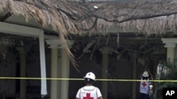 Mexican Red Cross rescuers check a damaged area of the Grand Riviera Princess Hotel in Playa del Carmen, Quintana Roo state, Mexico, Sunday Nov. 14, 2010.