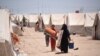 Newly arrived Iraqis from Fallujah collect emergency aid distributed at Amariyat al-Fallujah displacement camp. Photo: Karl Schembri/NRC