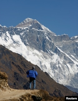 FILE - A tourist looks at a view of Mount Everest from the hills of Syangboche in Nepal on December 3, 2009. (REUTERS/Gopal Chitrakar/File Photo)