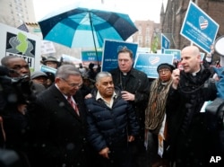 Catalino Guerrero, center left, stands with U.S. Sen. Bob Menendez, left, and Newark Archbishop Cardinal Joseph Tobin, center right, during a rally before attending an immigration hearing, March 10, 2017.