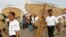 Cambodian people hold their kites before their kite flying at an annual traditional kite flying event in Phnom Penh, Cambodia, Friday, Dec. 5, 2008. Kite flying was one of the royal "ceremonies of the twelve months", according a National Kite Museum. (AP Photo/Heng Sinith)