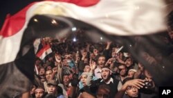 Egyptians celebrate the news of the resignation of President Hosni Mubarak, who handed control of the country to the military, Cairo, Egypt, February 11, 2011