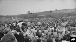 FILE - This is a general view of the crowd at the Woodstock Music and Arts Festival, Aug. 14, 1969. 