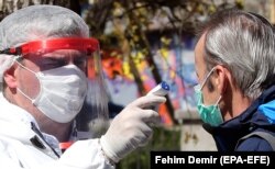 A man is tested for a coronavirus outside a hospital in Sarajevo, Bosnia and Herzegovina, 02 April 2020.