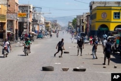 Youth play soccer in the middle of a normally busy downtown street, left empty by a transportation strike in Port-au-Prince, Haiti, Sept. 18, 2017.