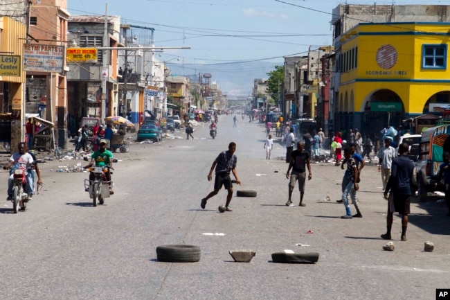 Youth play soccer in the middle of a normally busy downtown street, left empty by a transportation strike in Port-au-Prince, Haiti, Sept. 18, 2017.