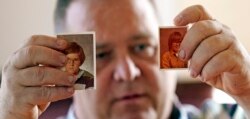 In this Thursday, Feb. 13, 2020, photo, James Kretschmer holds photographs of himself at age 11 and 12 during an interview in Houston. Kretschmer says he was sexually abused by a Scout leader over several months in the mid-1970s in the Spokane, Washingto