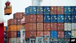 Container is loaded onto a cargo ship at Tianjin port in China. A United Nations report says China's growth is expected to be 6.5 percent this year. However, export-driven Asian economies could face problems if protectionist policies gain popularity.