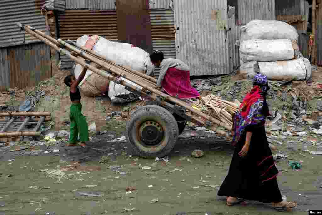 Children play with a cart in Dhaka, Bangladesh.