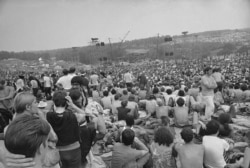 FILE - This is a general view of the crowd at the Woodstock Music and Arts Festival, Aug. 14, 1969.