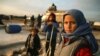 Syrian children prepare to flee with their families a camp for the displaced east of Sarmada town in northwestern Idlib province amid an ongoing pro-regime offensive, February 16, 2020. (Aaref Watad/AFP) 