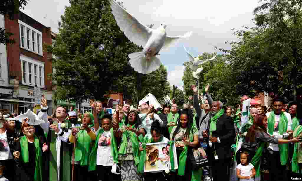 Doves are released during commemorations to mark the first anniversary of the Grenfell Tower fire, near the burned out social housing apartment block in west London.