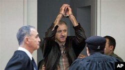 A May 27, 2010 file photo of Israeli Arab activist Amir Makhoul (C) arriving at Haifa's district court