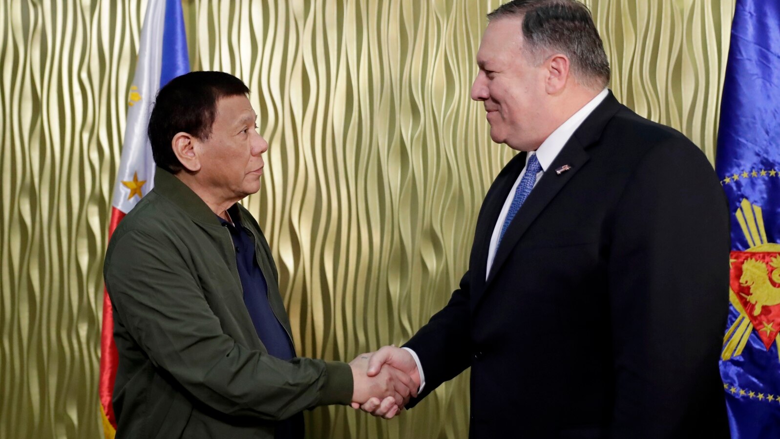 Philippine President Rodrigo Duterte, left, greets U.S. State Secretary Mike Pompeo upon arrival at Villamor Air Base in suburban Pasay city southeast of Manila, Philippines, Thursday, Feb. 28, 2019. 