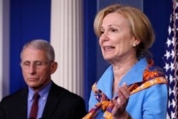 Dr. Deborah Birx, White House coronavirus response coordinator, speaks about the coronavirus on March 27, 2020, in Washington, as Dr. Anthony Fauci, director of the National Institute of Allergy and Infectious Diseases, listen.