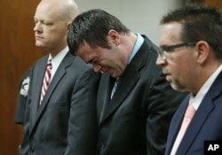 Daniel Holtzclaw, center, cries as he stands in front of the judge after the verdicts were read in his trial in Oklahoma City, Dec. 10, 2015.