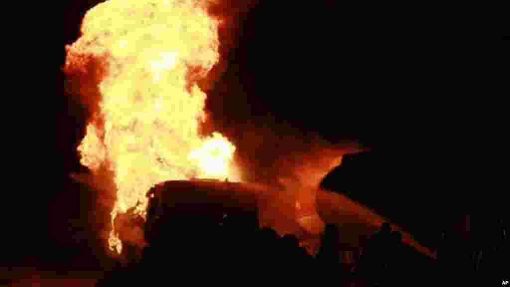 Firefighters try to contain a fire at an informal diesel fuel depot in Lagos, Nigeria on Thursday, Aug. 1, 2013.