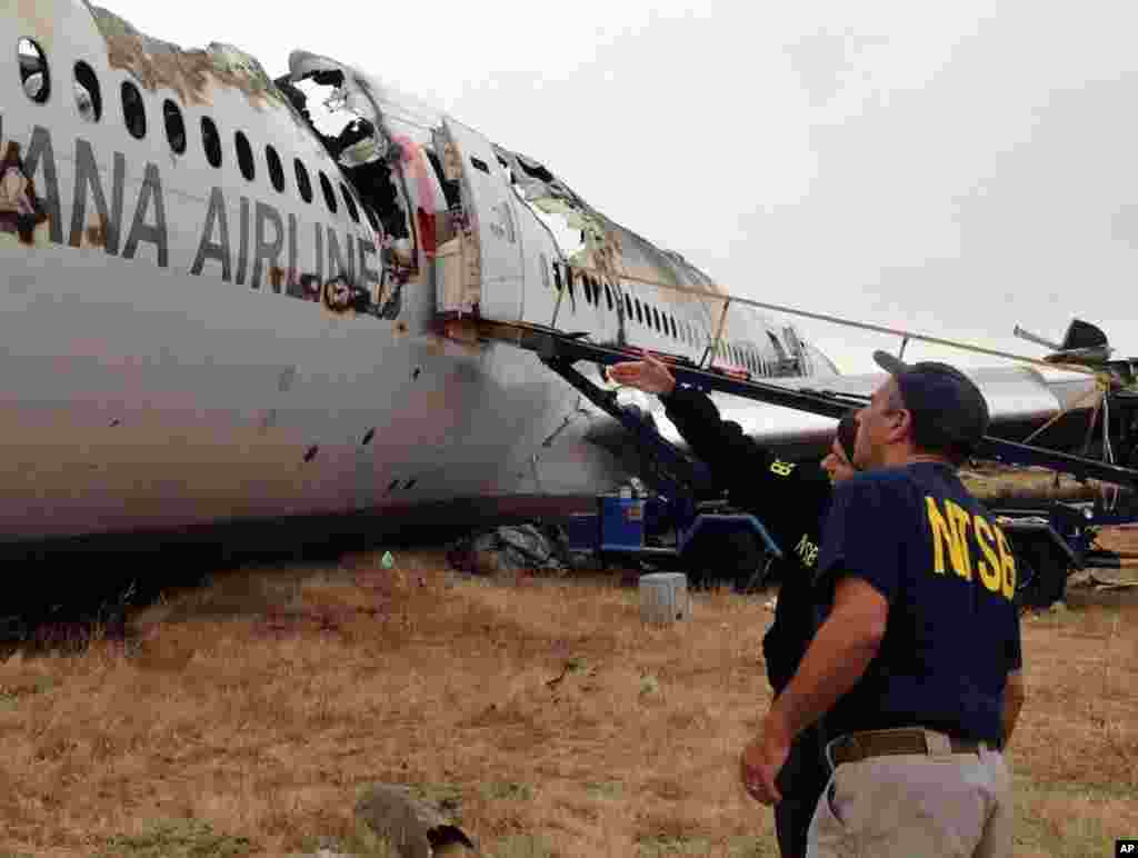 This NTSB photo shows Investigator in Charge Bill English and Chairperson Deborah Hersman discussing the progress of the investigation into the crash of Asiana Airlines Flight 214 in San Francisco, July 9, 2013.
