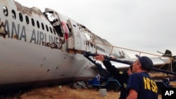 This NTSB photo shows Investigator in Charge Bill English and Chairperson Deborah Hersman discussing the progress of the investigation into the crash of Asiana Airlines Flight 214 in San Francisco, July 9, 2013.