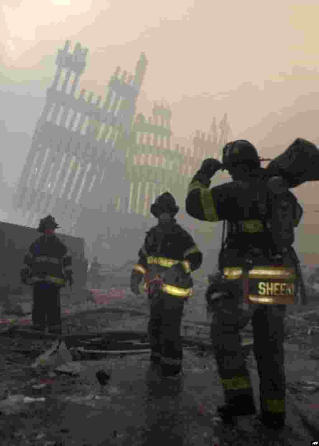 Firemen are deployed near the site of the World Trade Center in New York, Wednesday, Sept. 12, 2001. In the most devastating terrorist onslaught ever waged against the United States, knife-wielding hijackers crashed two airliners into the World Trade Cen