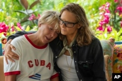 This image released by Netflix shows Annette Bening as Diana Nyad, left, and Jodie Foster as Bonnie Stoll, in a scene from the film "Nyad." (Kimberley French/Netflix via AP)