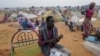 FILE - Adam Hassan sits outside his makeshift shelter in Adre, Chad, July 25, 2023. Sudan's sovereign council announced on Aug. 15, 2024, that it would allow use of the border crossing at Adre.