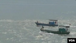 Boats sail on the South China Sea. 