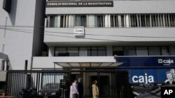 People pass Peru's National Judicial Council headquarters in Lima, July 19, 2018. The head of Peru's judicial branch, Duberli Rodriguez, is offering his resignation over the latest scandal to rock the South American nation.