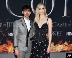 FILE - Actress Sophie Turner, right, and boyfriend musician Joe Jonas attend HBO's "Game of Thrones" final season premiere at Radio City Music Hall in New York.