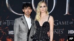 FILE - Actress Sophie Turner, right, and boyfriend musician Joe Jonas attend HBO's "Game of Thrones" final season premiere at Radio City Music Hall in New York. 