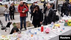 Mourners visit a makeshift memorial a day after a van struck multiple people along a major intersection in north Toronto, Ontario, Canada, April 24, 2018. 