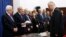 Palestinian Prime Minister elect Rami Hamdallah, right, takes oath of office in front of President Mahmoud Abbas June 6, 2013