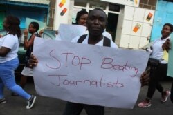 Liberian journalists protest in Monrovia on March 12, 2020, and some newspapers darkened their front pages, in protest at alleged harassment they face from security forces.