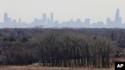 FILE - In this March 19, 2015, file photo, a thick haze of smog looms over the skyline of Chicago. A new study in the Proceedings of the National Academy of Sciences finds that America’s nitrogen oxides levels, a key ingredient in smog, aren’t falling as 