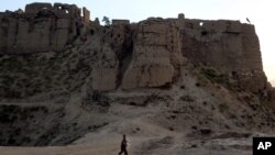 An Afghan boy walks in the old part of the city in Ghazni, a province west of Kabul, Afghanistan on Thursday, Aug. 23, 2007. 