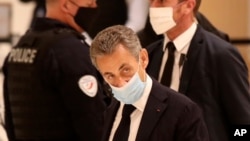Former French President Nicolas Sarkozy arrives at the courtroom, Nov. 23, 2020 in Paris. 