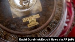 In this Dec. 9, 2019, photo a 141-year-old fruitcake, baked by Fidelia Ford, sits in the home of Dorothy Ford. (David Guralnick/Detroit News via AP)