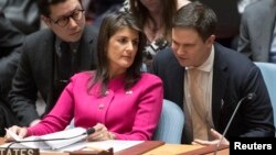 U.S. Ambassador to the United Nations Nikki Haley speaks to an aide before a Security Council meeting on the situation between Britain and Russia, April 18, 2018 at United Nations headquarters. 