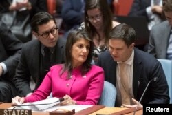 U.S. Ambassador to the United Nations Nikki Haley speaks to an aide before a Security Council meeting on the situation between Britain and Russia, April 18, 2018 at United Nations headquarters.