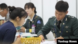 지난 28일 서울 코엑스에서 열린 대입정보 박람회에서 한 수험생(왼쪽)이 육군사관학교 입시 상담을 받고있다.