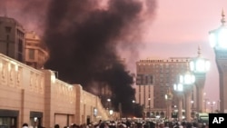 People stand near the site of an explosion in Medina, Saudi Arabia, July 4, 2016.