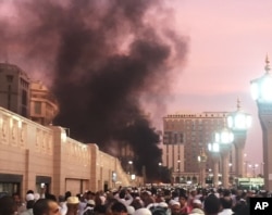 People stand by an explosion site in Medina, Saudi Arabia, July 4, 2016. (Courtesy of Noor Punasiya via AP)